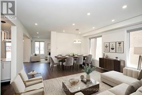East Gwillimbury (Holland Landing) apartment for rent - A well-lit, modern living room with a dining area in the background.