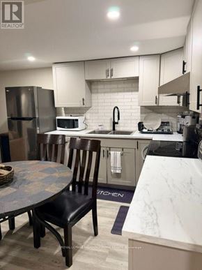 Vaughan (West Woodbridge) apartment for rent - A kitchen with a table and chairs.