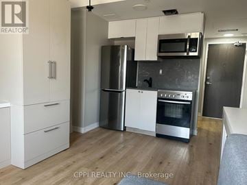 Oshawa (Central) condo for rent - A kitchen with white cabinets and stainless steel appliances.