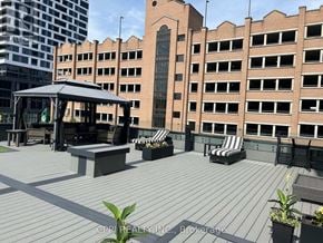 Oshawa (Central) condo for rent - A rooftop patio with a gazebo and chairs.