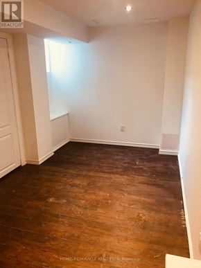 Mississauga (Central Erin Mills) apartment for rent - A room with wooden flooring and white walls.