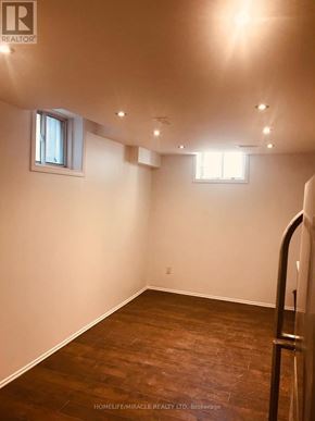 Mississauga (Central Erin Mills) apartment for rent - A room with wooden flooring and two windows.
