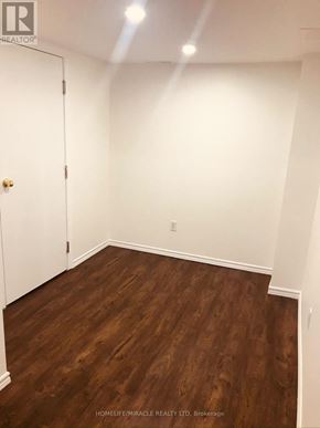 Mississauga (Central Erin Mills) apartment for rent - A room with wooden flooring and a white door.