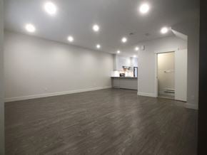 Surrey townhouse for rent - A room with wooden flooring and white walls.