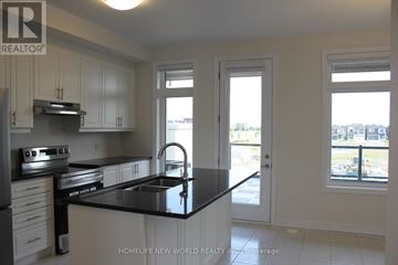Markham (Middlefield) townhouse for rent - A kitchen with white cabinets and black countertops.