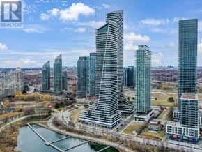 Toronto (Mimico) condo for rent - A cityscape with a prominent building in the foreground and other buildings in the background.