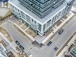 Toronto (Mimico) condo for rent - A tall building with a parking lot in front of it.