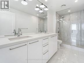 Toronto (Mimico) condo for rent - A white bathroom with a sink, mirror, and shower.