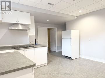 Toronto (Newtonbrook East) apartment for rent - A kitchen with white cabinets and a refrigerator.