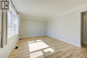 Kitchener apartment for rent - A room with wooden flooring and a window letting in sunlight.