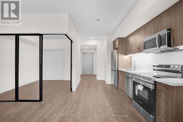 Welland (Broadway) condo for rent - A kitchen with wooden cabinets and a white countertop.