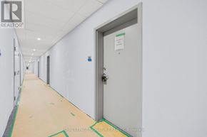 Welland (Broadway) condo for rent - A white door with a sign on it in a hallway.