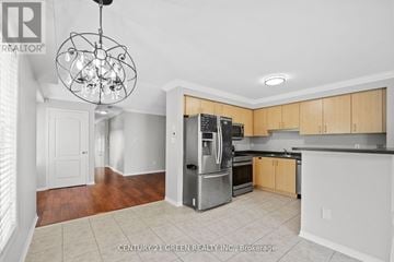 Mississauga (Churchill Meadows) apartment for rent - A kitchen with wooden cabinets and a black countertop.