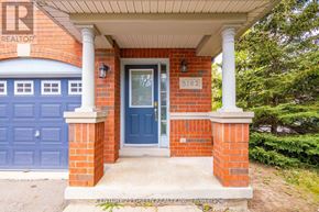 Mississauga (Churchill Meadows) apartment for rent - A house with a blue door and a brick pillar.