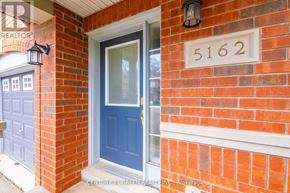 Mississauga (Churchill Meadows) apartment for rent - A red brick house with a blue door and a sign that reads 5162.