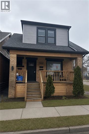 Hamilton apartment for rent - A house with a black front door and a small porch.