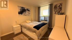 Mississauga (Lakeview) condo for rent - A bedroom with a large bed and a painting on the wall.