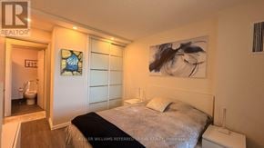 Mississauga (Lakeview) condo for rent - A bedroom with a bed, nightstand, and a painting on the wall.