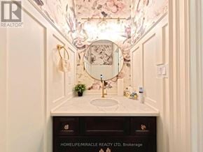 Waterloo townhouse for rent - A bathroom with a floral ceiling and a sink with a gold faucet.