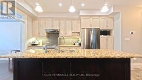 Waterloo townhouse for rent - A kitchen with a granite countertop and a refrigerator.