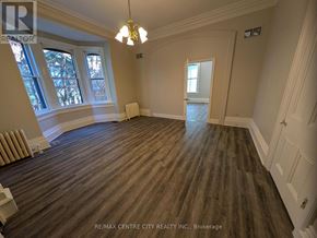 London East (East K) multi-family for rent - A large empty room with wood flooring and white walls.