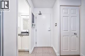 Toronto (Niagara) condo for rent - A white door with a black handle is in a white room.