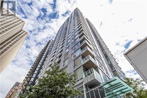 Ottawa apartment for rent - A tall building with balconies is seen against a cloudy sky.