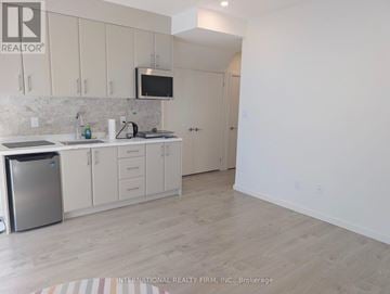 Richmond Hill (Doncrest) townhouse for rent - A kitchen with white cabinets and a refrigerator.