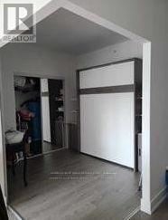 Toronto (Banbury-Don Mills) condo for rent - A bedroom with a white door and a white chair.