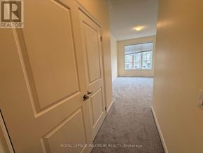 Bradford West Gwillimbury (Bradford) townhouse for rent - A hallway with a carpeted floor and white walls.