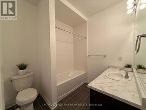 Bradford West Gwillimbury (Bradford) townhouse for rent - A white bathroom with a toilet, sink, and bathtub.