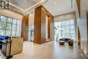 Toronto (Mimico) condo for rent - A modern office lobby with a reception desk and a large wooden partition.