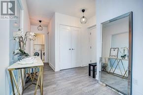 Toronto (Mimico) condo for rent - A room with a table, chairs, and a mirror.