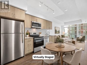 Toronto (Humber Heights) condo for rent - A modern kitchen with a stainless steel refrigerator and a dining table set for four.