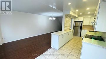 Mississauga (Churchill Meadows) townhouse for rent - A kitchen with white cabinets and a countertop is shown.