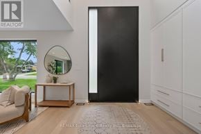 Burlington (Shoreacres) apartment for rent - A modern living room with a black door and a round mirror on the wall.