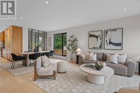 Burlington (Shoreacres) apartment for rent - A modern living room with a dining area and a kitchen in the background.