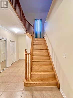 Whitby (Williamsburg) apartment for rent - A wooden staircase leads up to a bedroom with a blue lighted window.