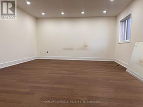 Whitby (Williamsburg) apartment for rent - A room with wooden flooring and white walls, with a window on the right wall.