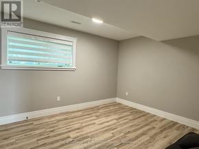 Saugeen Shores multi-family for rent - A room with wooden flooring and a window with blinds.