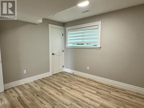 Saugeen Shores multi-family for rent - A room with wooden flooring and a window with blinds.