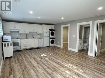 Saugeen Shores duplex for rent - A kitchen with white appliances and wooden floors.
