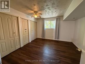 Niagara Falls (Ascot) apartment for rent - A room with wooden floors and a ceiling fan.