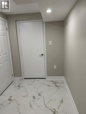 Mississauga (Churchill Meadows) apartment for rent - A white door is in a hallway with marble flooring.
