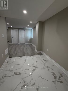 Mississauga (Churchill Meadows) apartment for rent - A hallway with marble flooring and white walls.