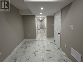 Mississauga (Churchill Meadows) apartment for rent - A hallway with marble flooring and white walls.