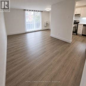 Toronto (Ionview) condo for rent - A spacious room with wooden flooring and white walls.