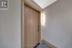 Vaughan (Vaughan Corporate Centre) condo for rent - A wooden door with a handle and a light on the wall.