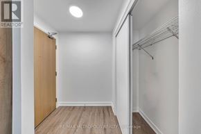 Vaughan (Vaughan Corporate Centre) condo for rent - A hallway with a wooden floor and white walls.