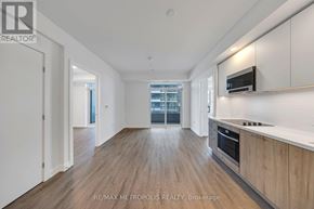 Vaughan (Vaughan Corporate Centre) condo for rent - A spacious kitchen with wooden floors and white walls.